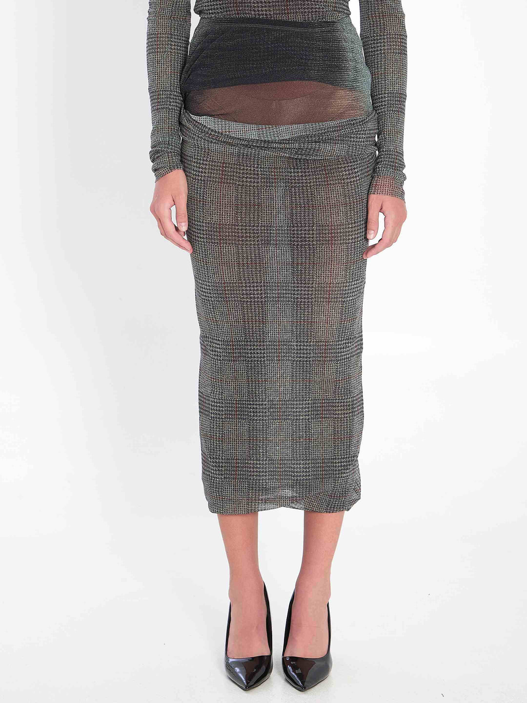 Person wearing a patterned skirt on a white background