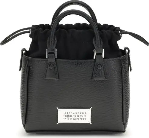 Black handbag with a visible brand label on a white background