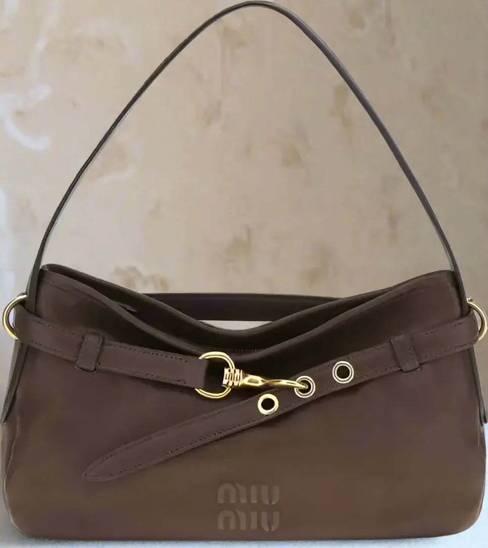 Brown handbag with gold accents on a white background