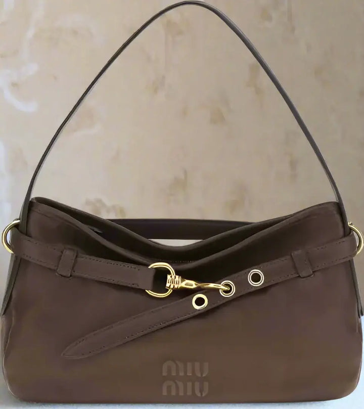 Brown handbag with gold accents on a white background