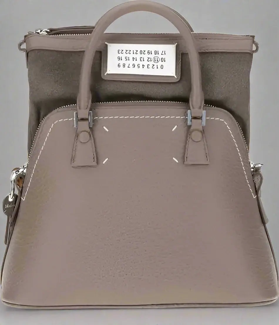 Gray handbag with visible brand label on a white background