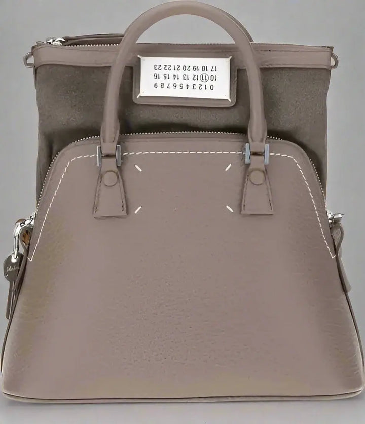 Gray handbag with visible brand label on a white background