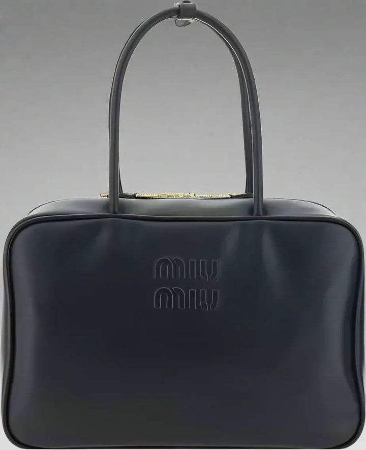 Black handbag with a brand logo on a white background