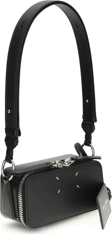 Black handbag with a strap on a white background