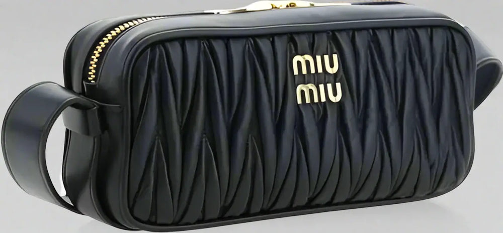 Black quilted handbag with gold accents and 'Miu Miu' logo on a white background