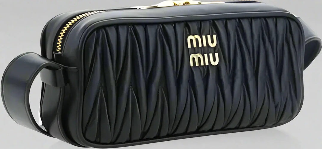 Black quilted handbag with gold accents and 'Miu Miu' logo on a white background