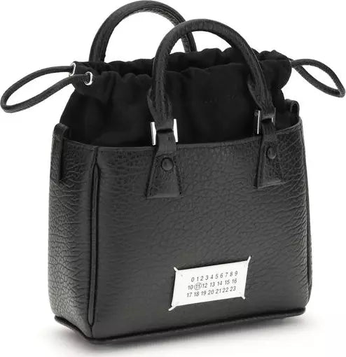 Black leather handbag with drawstring top on a white background