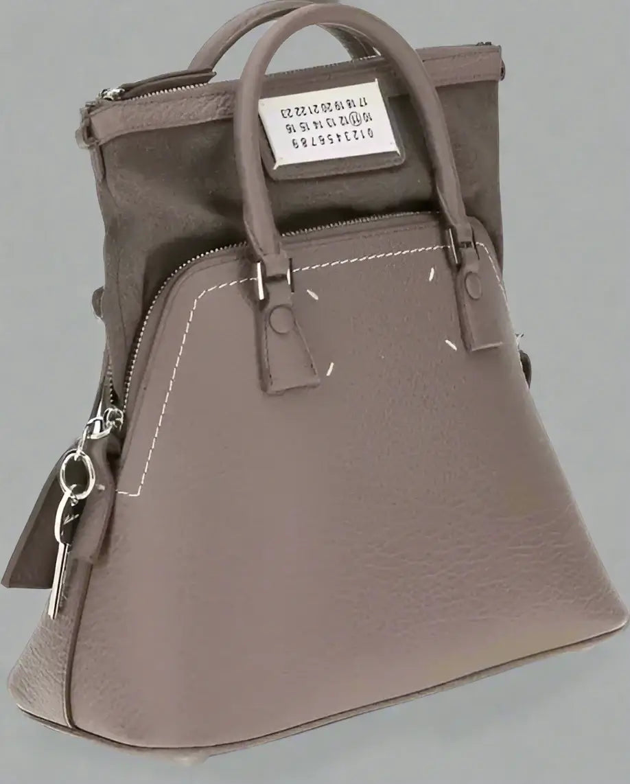 Gray handbag with a visible brand label on a white background
