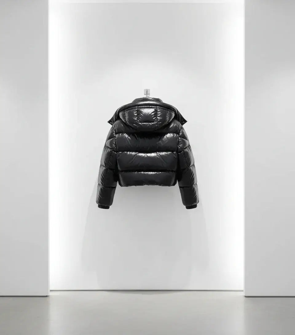 Black puffer jacket on a white background