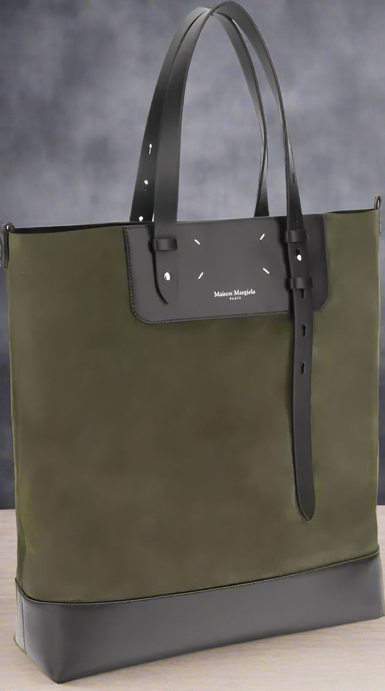 Green and black tote bag with a visible brand logo on a white background