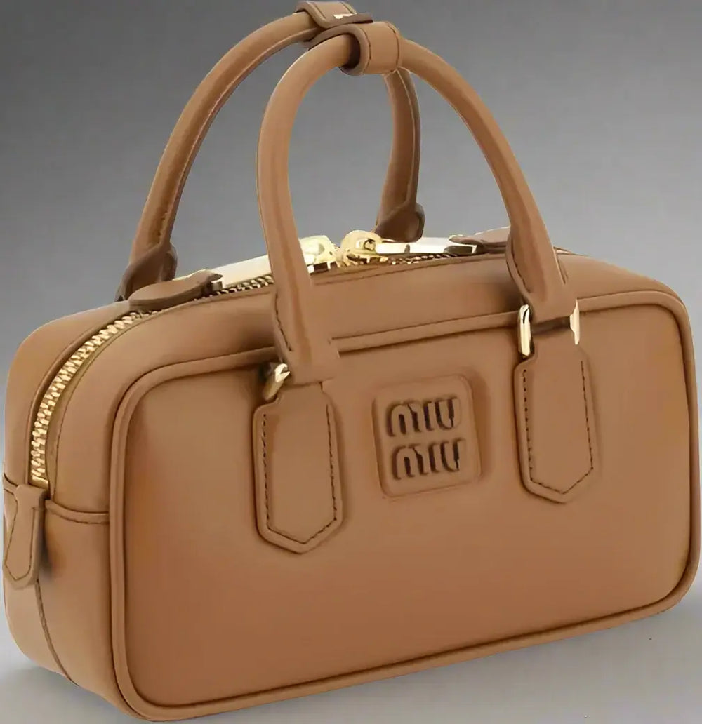 Brown handbag with gold accents and Miu Miu logo on a white background