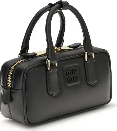 Black handbag with gold accents on a white background