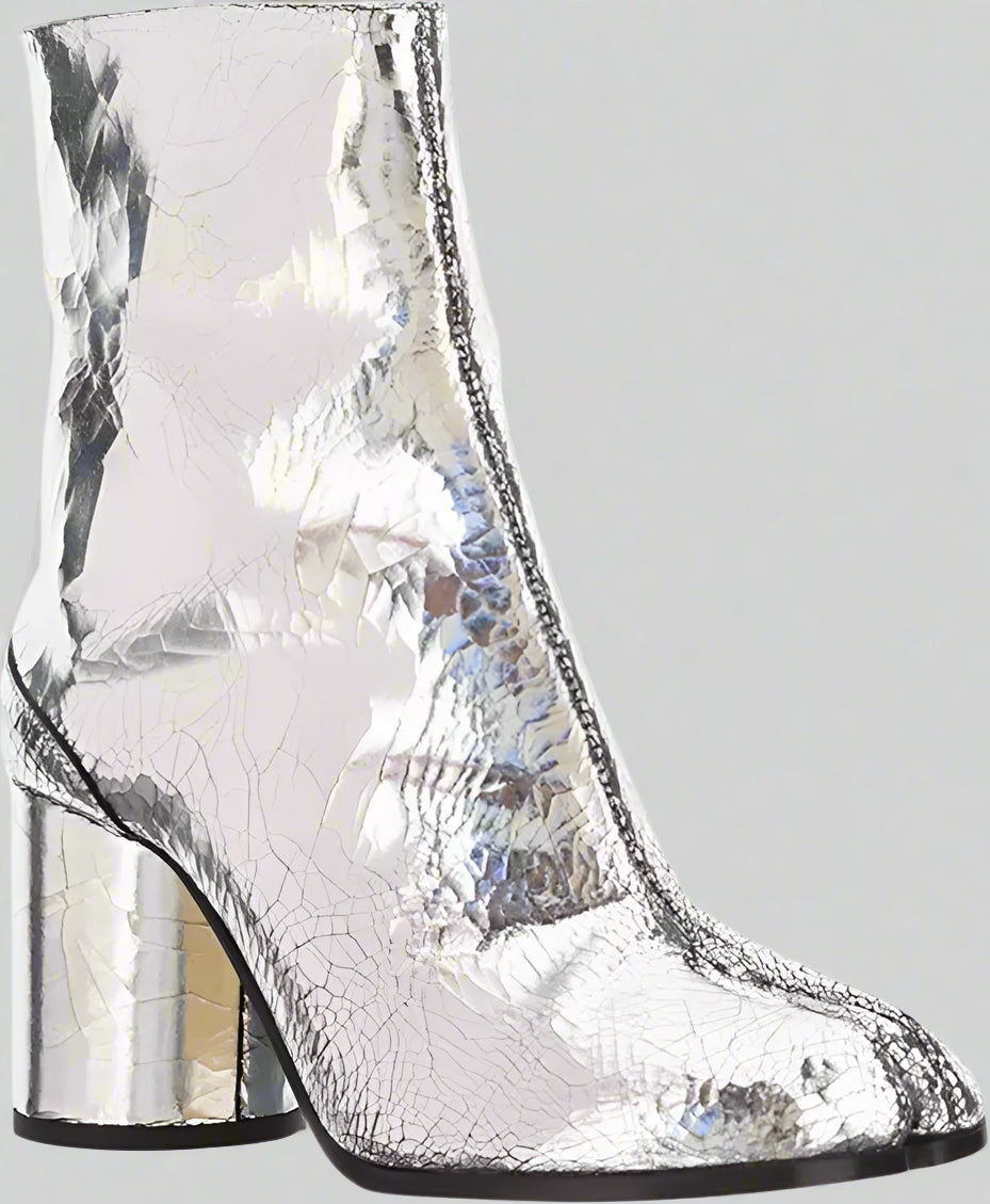 Silver metallic ankle boot with block heel on a white background