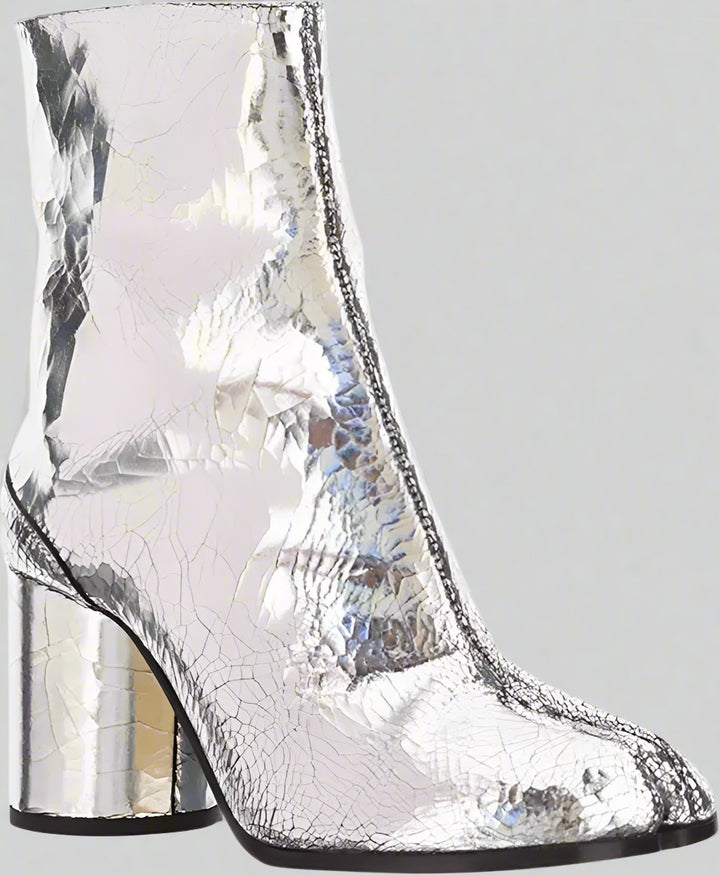 Silver metallic ankle boot with block heel on a white background