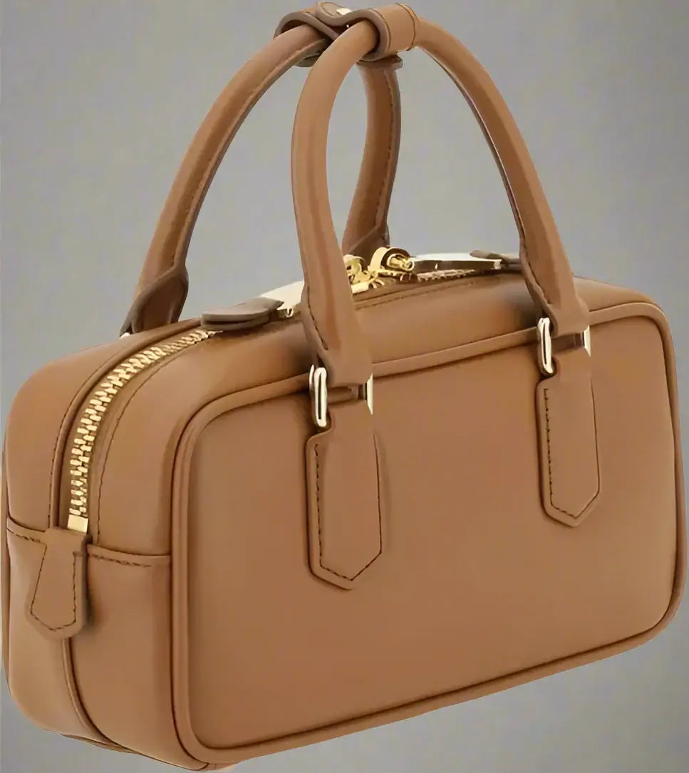 Brown handbag with gold zippers on a white background