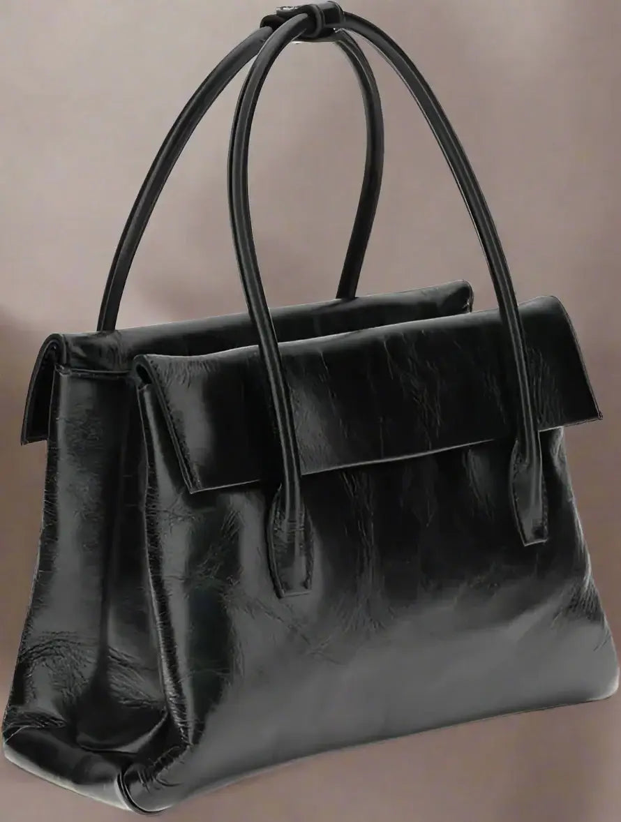 Black leather handbag with handles on a white background