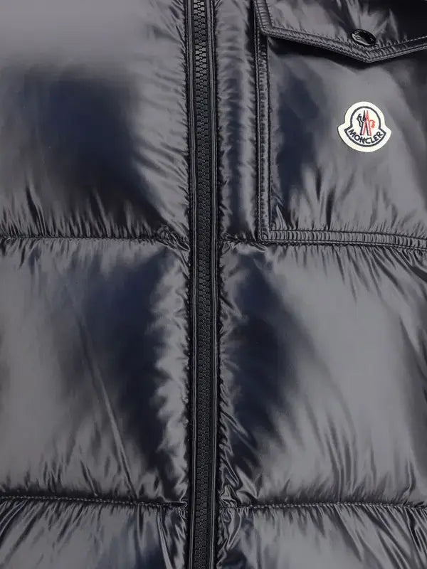 Dark blue puffer jacket with a brand logo on a dark background