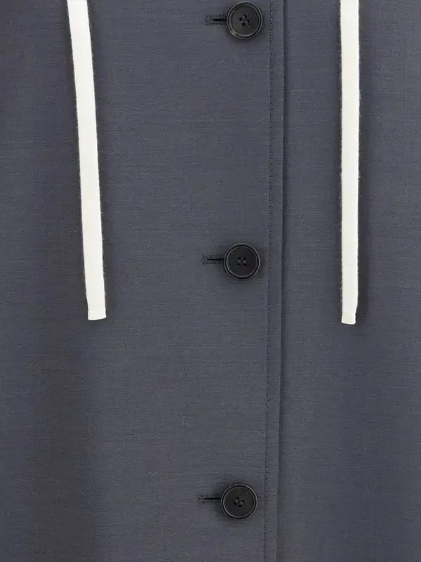 Close-up of a dark gray coat with buttons and white drawstrings on a matching background