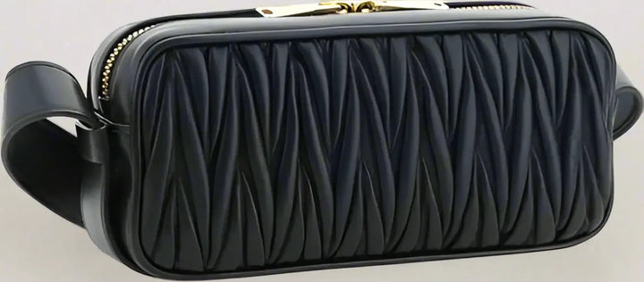 Black quilted handbag with a strap on a white background