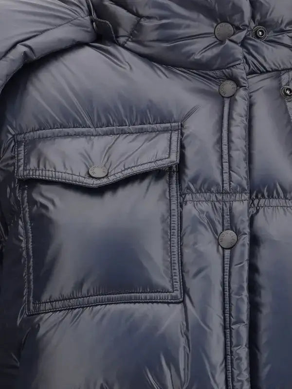 Close-up of a blue puffer jacket with a pocket and buttons.
