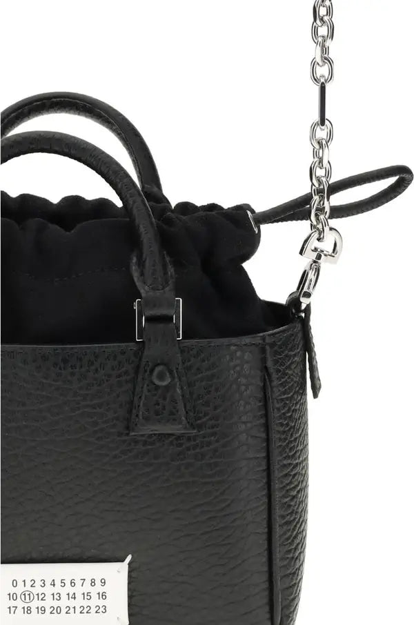 Black leather handbag with chain strap on a white background