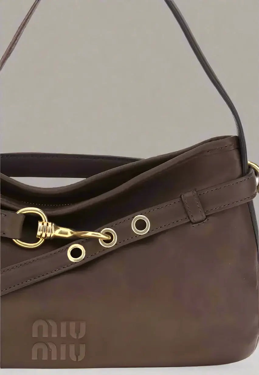 Brown handbag with gold accents and Miu Miu logo on a white background