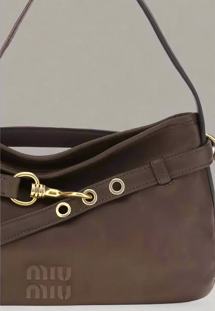 Brown handbag with gold accents and Miu Miu logo on a white background