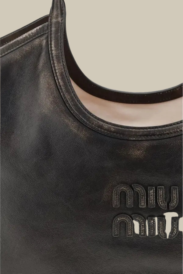 Black handbag with 'miu miu' logo on a white background