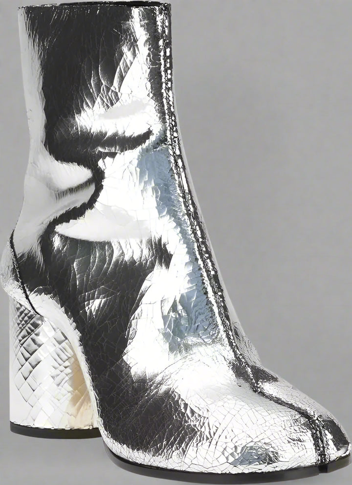 Silver metallic ankle boot on a white background