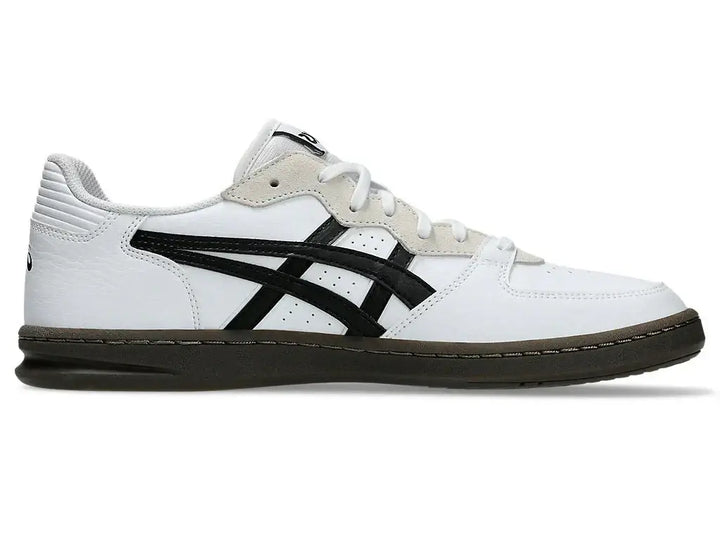 White sneaker with black logo on a white background