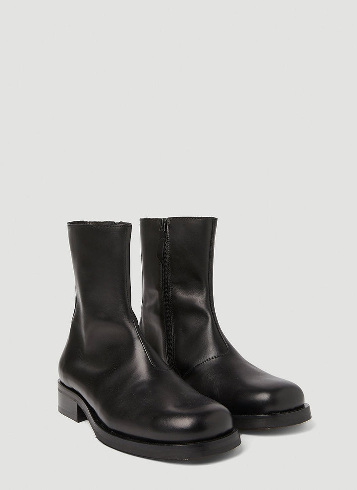 Pair of black leather ankle boots on a light gray background