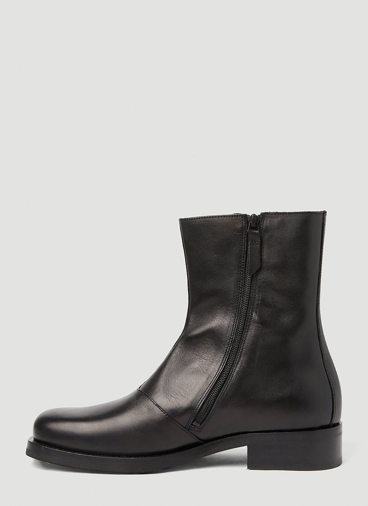 Black leather ankle boot on a light gray background