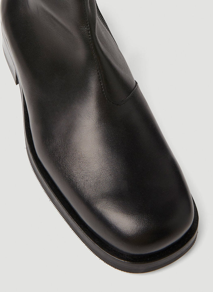 Black leather shoe on a light gray background