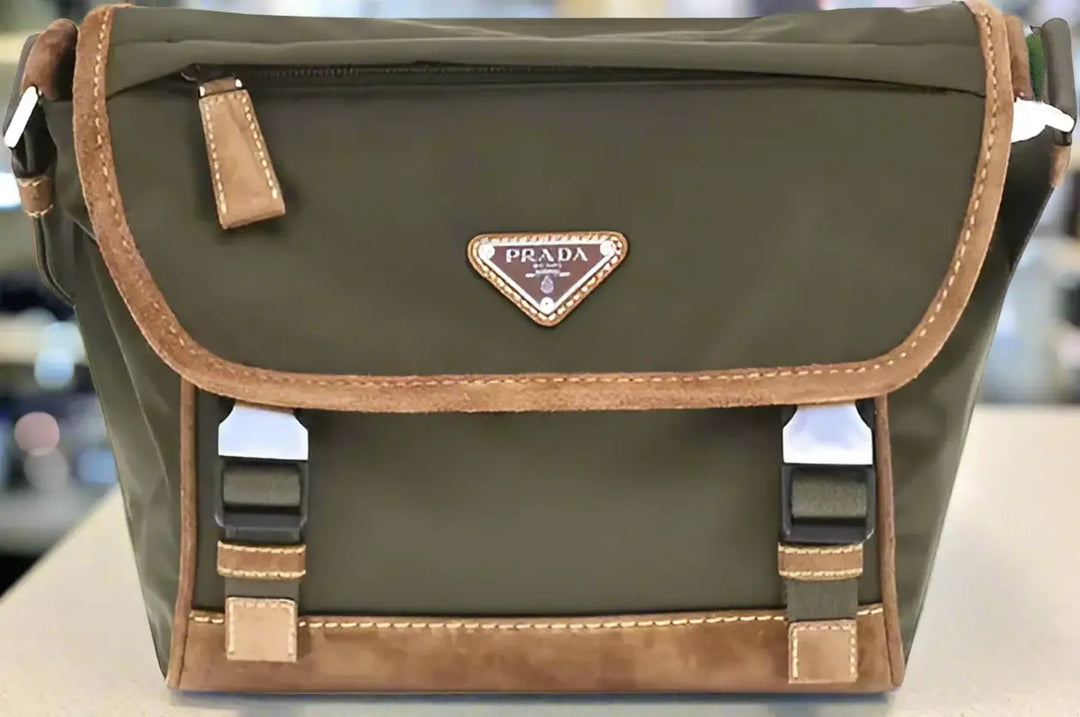 Green Prada bag with brown accents on a white background