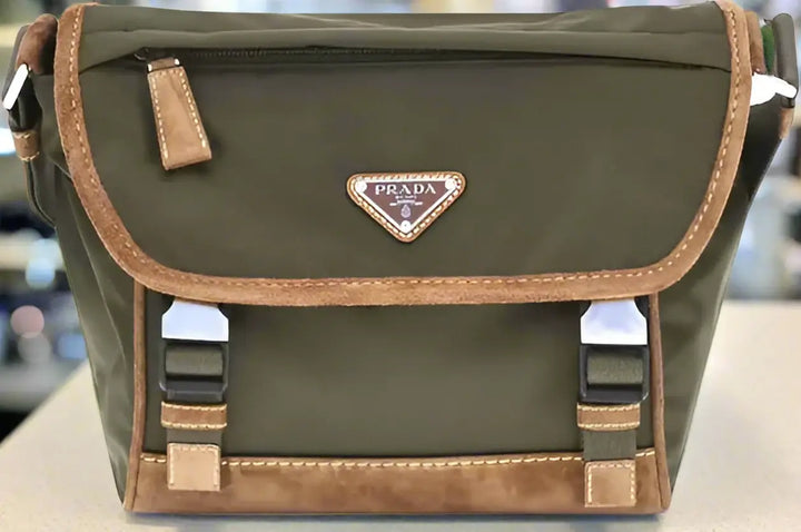 Green Prada bag with brown accents on a white background