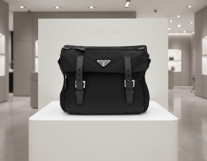 Black Prada bag with straps on a white background