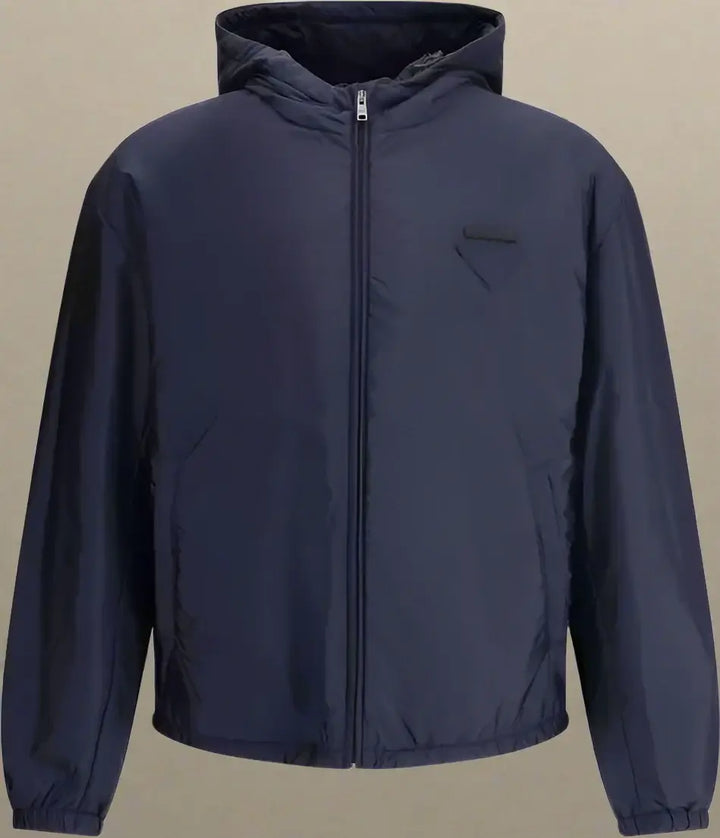 Navy blue jacket with a hood on a white background