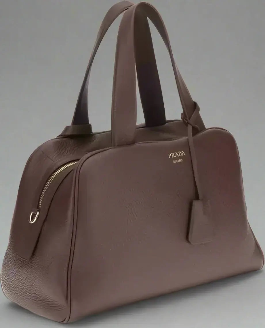 Brown leather handbag with Prada logo on a white background
