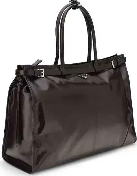 Black handbag with a glossy finish on a white background