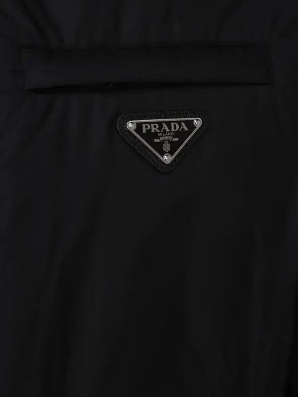 Close-up of a Prada logo patch on a black garment