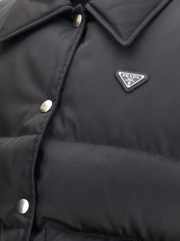 Close-up of a black puffer jacket with Prada logo