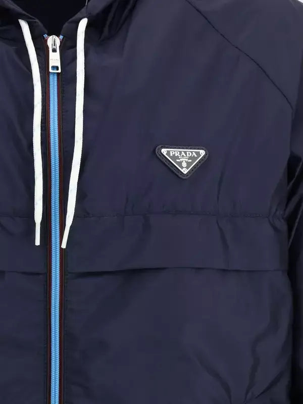 Navy blue jacket with a Prada logo on a black background