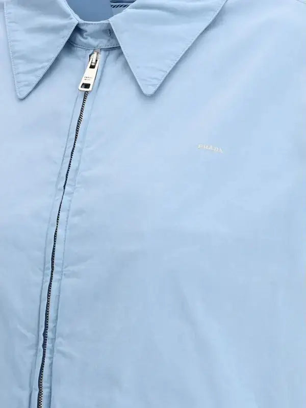 Light blue jacket with a zipper and brand logo on a light blue background