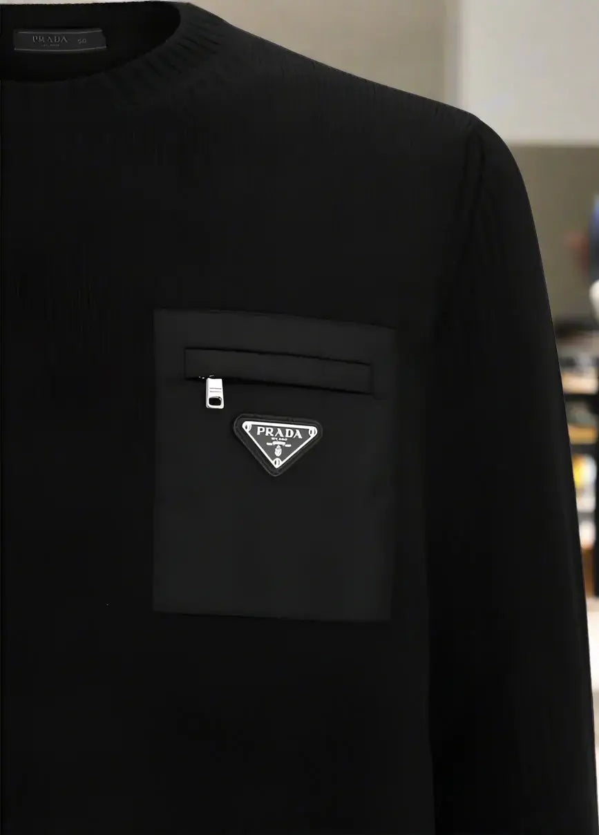 Black sweater with Prada logo on a white background