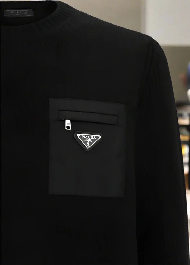 Black sweater with Prada logo on a white background