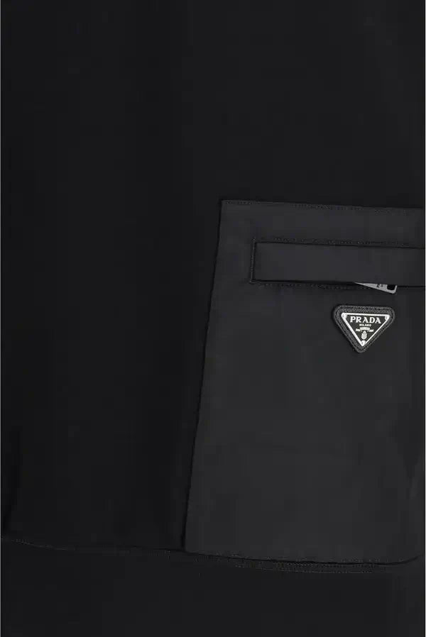 Black jacket with Prada logo patch on a black background