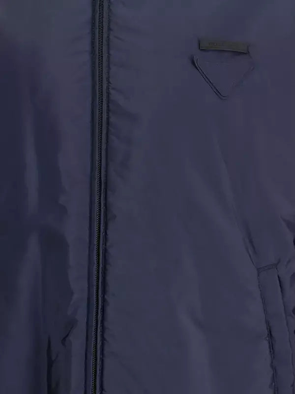 Close-up of a dark blue jacket with a zipper and pocket detail.