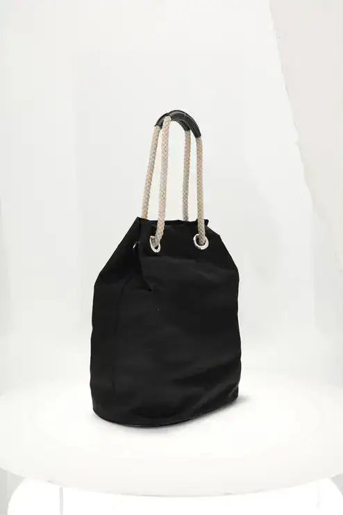 Black drawstring bag with rope handles on a white background