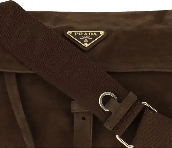 Brown Prada bag with strap and logo on a white background