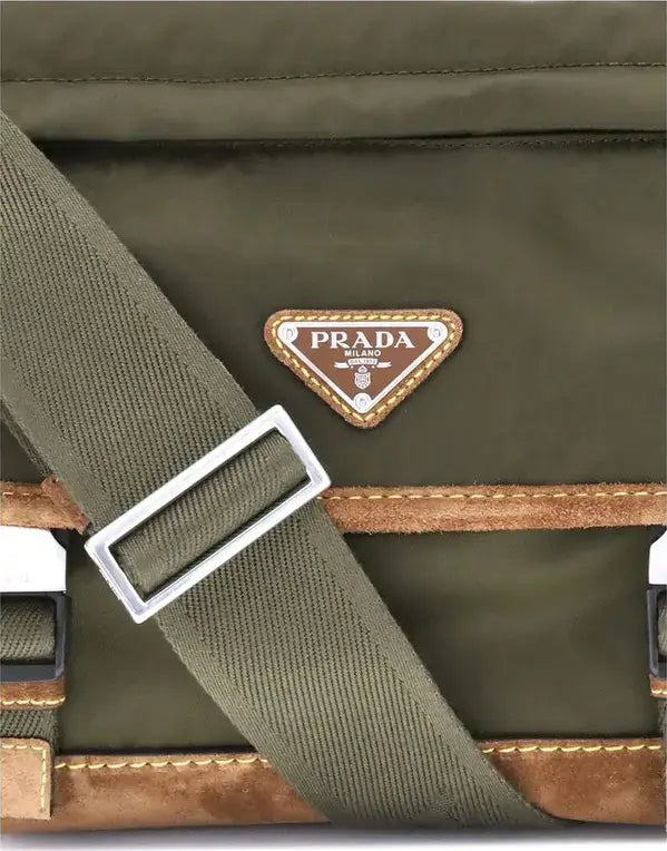 Green Prada bag with a strap and brown accents on a gray background